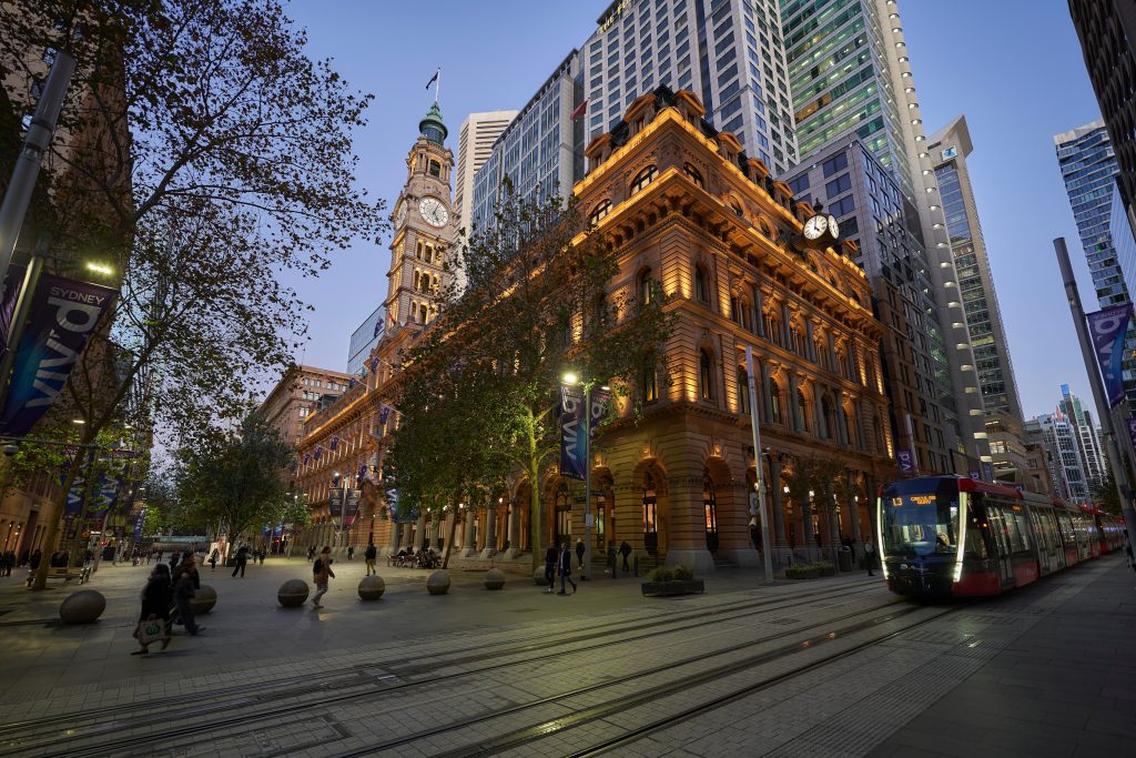 Historic city hall building with evening illumination in Sydney CBD.