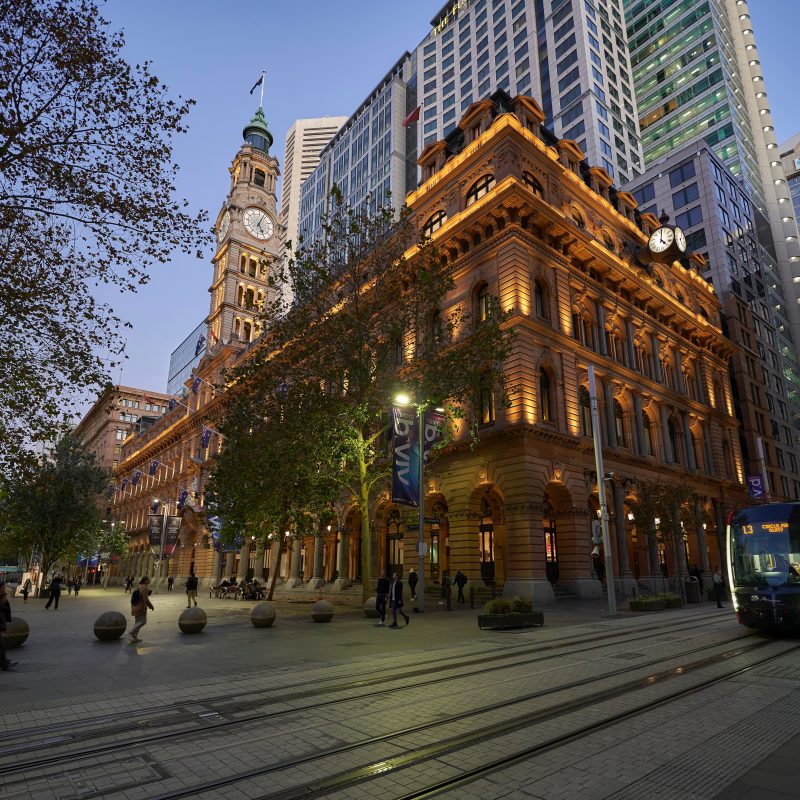 Historic city hall building with evening illumination in Sydney CBD.
